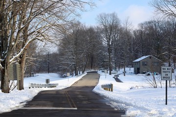 Fototapeta na wymiar The long empty road in the snowy landscape.