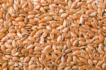 Close up of brown flax seeds background, top view