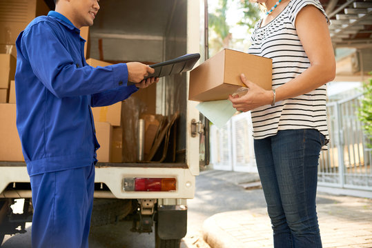 Cropped image of woman receiving box from online store