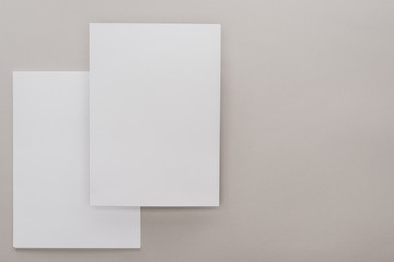 top view of white empty papers on grey background