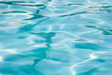 Fototapeta na wymiar water texture with reflections in swimming pool as a background
