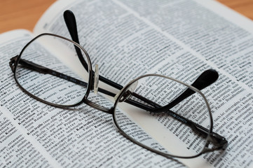Closeup of Reading Glasses on Book