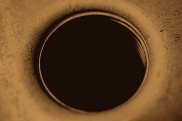 Monochrome background image of oil filter close up. Art macro photography of auto part in sepia tones.