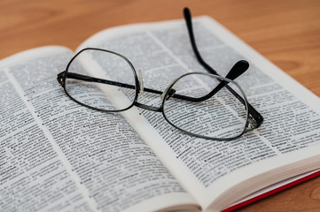 Closeup of Reading Glasses on Book