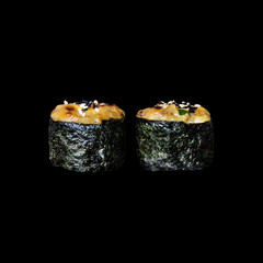 Sushi. Gunkan rolls with eel, isolated in black background