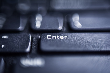 Electronic collection - close-up laptop keyboard. The focus on the Enter key. Toning is black.