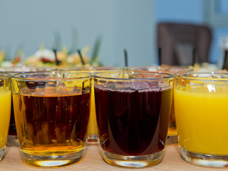 Multicolored juices in glasses.
