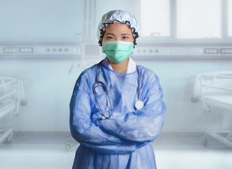 successful Asian Chinese medicine doctor woman in hospital scrubs and mask posing isolated at clinic patient bed in medical health care as corporate physician portrait