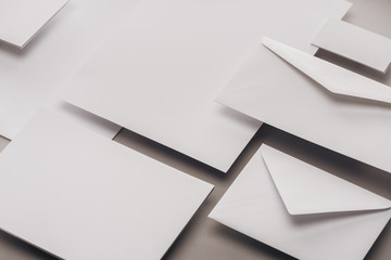 flat lay with blank white cards and envelopes on grey background