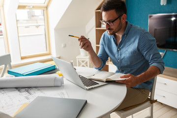 Mid age man working from home .He using laptop and working on new project.