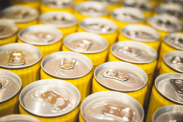 Standard yellow energy cans accumulated in the market ranked views from above with repetition to be consumed. Refreshment coolant crates