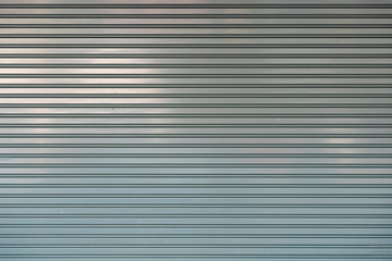 close-up shot of aluminum steel metal roller shutter door texture for backdrop design.