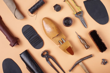 Tools for shoe repair on blue background