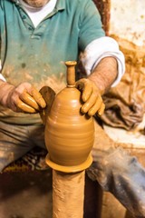pottery, workshop, ceramics art concept - male master works with hands and potter wheel . 