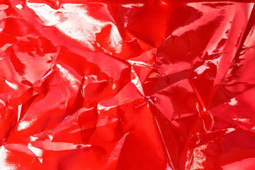 red glossy texture of crumpled metal