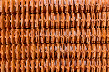 Stack of roof tiles traditional clay for temple construction process in vintage style which textured of surface natural color background.