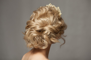 Beautiful blond girl in the image of a bride with a tiara in her hair. Picture taken in the studio on a gray background. Beauty baby face. Wedding image. © hamara