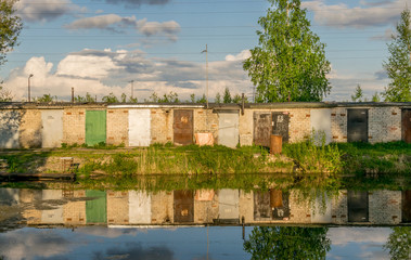 reflections of garage doors in water on a sunny day. 