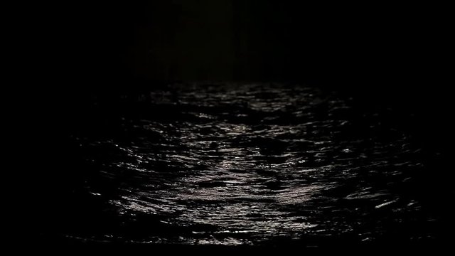 Moonlight path with low fool moon above the sea