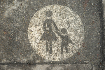 Sign on the street for pedestrian, woman and child