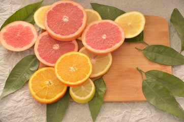 Sliced oranges and grapefruits on table