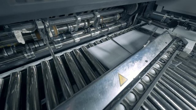 Industrial press is relocating printed pieces of paper