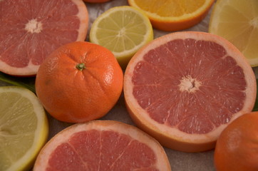 Sliced oranges and grapefruits on table