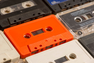 Several old analog cassette tapes of various colors