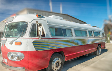 Fototapeta premium Beautiful colorful vintage bus on a sunny day with light rays coming from the sky, holiday concept