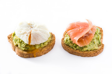 Toasted breads with avocado, poached eggs and salmon isolated on white background. 