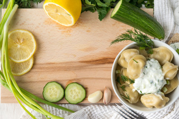 cutting Board, greens, dumplings with greens and yogurt, cucumber, lemon, garlic, food