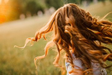 girl runs hair curls develop glow sun
