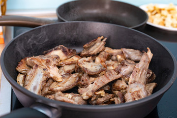  Rack of lamb barbecue on black grilled pan. Process the roasting meat. Grilled food.