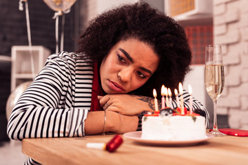 Unhappy afro American woman being alone at home