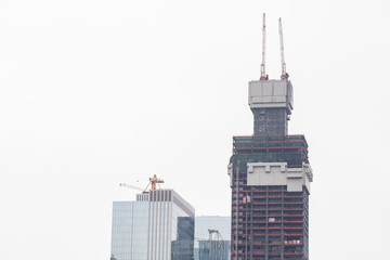 construction of multi-storey building, crane on the roof of the house