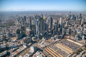 Fototapeta na wymiar MELBOURNE - SEPTEMBER 8, 2018: Aerial view of city skyline and car parking from helicopter. Melbourne attracts 15 million people annually