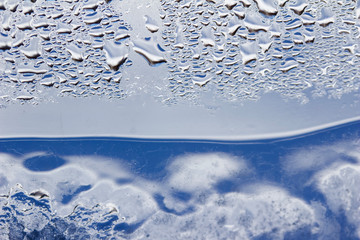 Whimsical macro abstract art background of frozen water condensation on a glass window in winter 