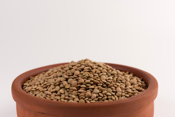 Yellow lentil in a bowl isolated on white background