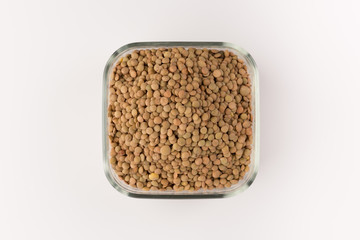 Yellow lentil in a bowl isolated on white background