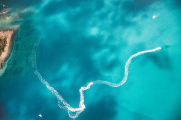 Aerial view of watercrafts speeding up on the ocean
