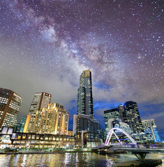 Night city view of buildings along Yarra River, Melbourne. Starry night