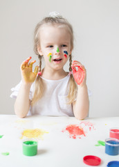 Caucasian Little Girl Painting with Colorful Hands Paints at Home Early Education Preparing for...