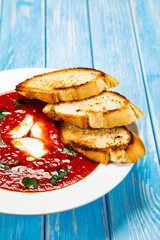 Tomato soup with mozzarella on white background