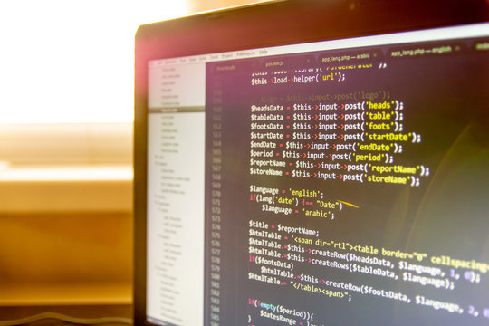 Modern software development background: nice looking laptop with programm on display.