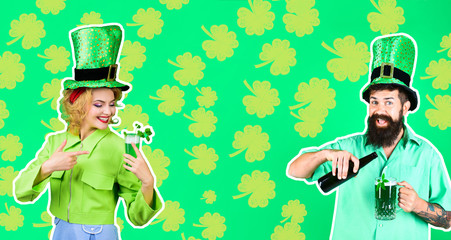 St Patrick's Day. Happy bearded man in leprechaun hat pours beer in glass. Bearded leprechaun. Woman in top hat points at glass with beer. Couple drinking in pub. Irish beer. Green beer. Happy clover.