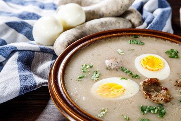 Sour rye soup on wooden table