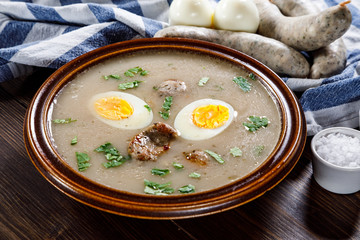 Sour rye soup on wooden table