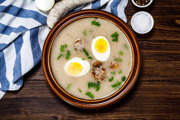 Sour rye soup on wooden table