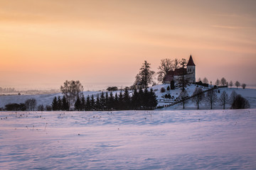 Europe, country Slovakia, region Turiec. Sunrise on winter landscape, beautiful church in the village of Abramova.