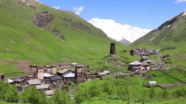 Sky with clouds and mountains. Svan towers in Ushguli, highest inhabited village in Europe. Caucasus, Upper Svaneti Georgia.